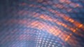 Progressive rhythmic orange and gray shaded light layers seen through a net fence pattern