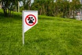 Prohibiting sign you can not walk with a dog on green lawn. Walking no animals Royalty Free Stock Photo