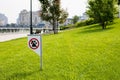 Prohibiting sign you can not walk with a dog on green lawn. Walking no animals Royalty Free Stock Photo
