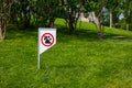 Prohibiting sign you can not walk with a dog on green lawn. Walking no animals Royalty Free Stock Photo