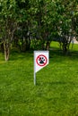 Prohibiting sign you can not walk with a dog on green lawn. Walking no animals Royalty Free Stock Photo