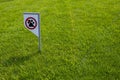 Prohibiting sign you can not walk with a dog on green lawn. Walking no animals Royalty Free Stock Photo