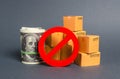 The prohibition sign NO blocks a bundle of dollars money and cardboard boxes. Embargo, trade wars. Restriction on importation