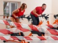 Indoor bycicle cycling in gym Royalty Free Stock Photo