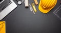 Project blueprints, yellow hard hat and computer laptop on black color, top view Royalty Free Stock Photo