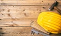 Project construction. Yellow hard hat and tools on wooden desk, copy space, top view Royalty Free Stock Photo