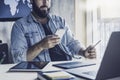 Project manager using digital devices and gadgets in work. Man checking email and sending messages on mobile phone Royalty Free Stock Photo