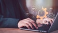 Project managers optimize workflow efficiency systems, Hands typing on laptop with gear, clock, virtual icons represent time Royalty Free Stock Photo