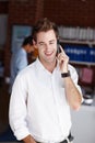 The project is moving full-steam. A handsome young businessman taking a call from a client.