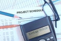 Project schedule With gant chart, eyeglasses, pencil, pen and calculator showing syntax error message. Royalty Free Stock Photo