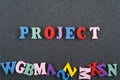 PROJECT word on black board background composed from colorful abc alphabet block wooden letters, copy space for ad text. Learning