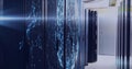 Projecting network patterns on central server cabinets in corridor, with overhead cable trays Royalty Free Stock Photo
