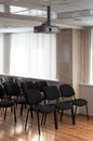 Projector hang on ceiling of empty sunlit meeting room Royalty Free Stock Photo