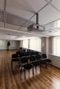 Projector hang on ceiling of empty sunlit meeting room