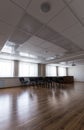 Projector hang on ceiling of empty sunlit meeting room Royalty Free Stock Photo