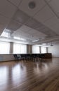 Projector hang on ceiling of empty sunlit meeting room Royalty Free Stock Photo