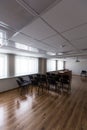 Projector hang on ceiling of empty sunlit meeting room Royalty Free Stock Photo