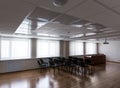 Projector hang on ceiling of empty sunlit meeting room Royalty Free Stock Photo