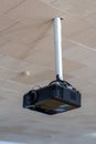 A projector hanging from the ceiling in a room Royalty Free Stock Photo