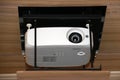 Projector hanging on meeting room ceiling Royalty Free Stock Photo