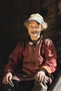Portrait of a old nepalese man in cap in his house