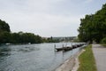 Promenade along Rhine river in Schaffhausen, Switzerland. There are wooden boats moored along the river bank. Royalty Free Stock Photo