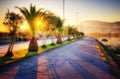 Promenade along the river bank at warm sunset