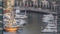 Promenade and canal in Dubai Marina with luxury skyscrapers and yachts around timelapse, United Arab Emirates Royalty Free Stock Photo