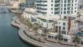 Promenade and canal in Dubai Marina with luxury skyscrapers and yachts around timelapse, United Arab Emirates Royalty Free Stock Photo