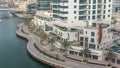 Promenade and canal in Dubai Marina with luxury skyscrapers and yachts around , United Arab Emirates Royalty Free Stock Photo
