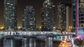 Promenade and canal in Dubai Marina timelapse at night, UAE.