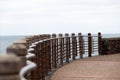 Promenade with metallic handrail and sea