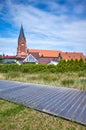 Promenade in Nowe Warpno with church tower in background, Poland Royalty Free Stock Photo