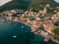 Promenade with old houses and moored boats. Tivat, Montenegro. Drone