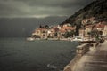 Promenade in old medieval town Perast in rainy overcast day with puddles in Montenegro Royalty Free Stock Photo