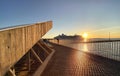 Promenade pier in harbor sunset and sea water wave reflection people walk and relax modern urban  architecture port of Tallinn Est Royalty Free Stock Photo