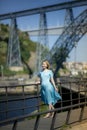 On a promenade in Porto, Portugal stands a woman in a blue dress. Royalty Free Stock Photo