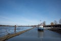 Promenade riverside, boat, ship and bridge toward pier, pontoon or buoy on Rhine River in DÃÂ¼sseldorf, Germany.