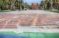 Promenade with tourists, map on the paving and The Arc de Triomf Triumphal Arch in the distance.