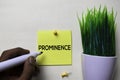 Prominence text on sticky notes isolated on office desk