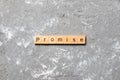 Promise word written on wood block. Promise text on cement table for your desing, concept Royalty Free Stock Photo