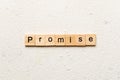 Promise word written on wood block. Promise text on cement table for your desing, concept Royalty Free Stock Photo