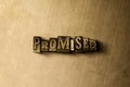 PROMISED - close-up of grungy vintage typeset word on metal backdrop