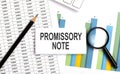 PROMISSORY NOTE text on white card on the chart background