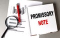 PROMISSORY NOTE text written on notebook with chart