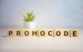 Promocode - word from wooden blocks with letters, coupon, promotion code, promo code concept, top view