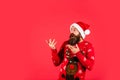 Promoting goods. Santa man. New year party. Christmas time. Have fun. Finding perfect present. Bearded man santa hat