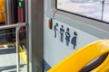 Promoting Inclusive Urban Mobility: A Detailed View of Priority Seating Icons in a City Bus Ensuring Accessibility and Courtesy
