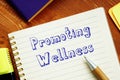 Promoting Wellness sign on the piece of paper