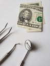 dentist utensils for oral review and american banknote of five dollar